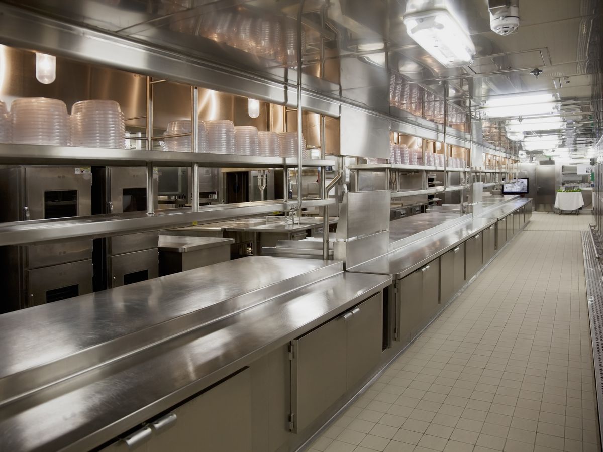 Commercial kitchen layout with stainless steel benching, shelving and under-bench units