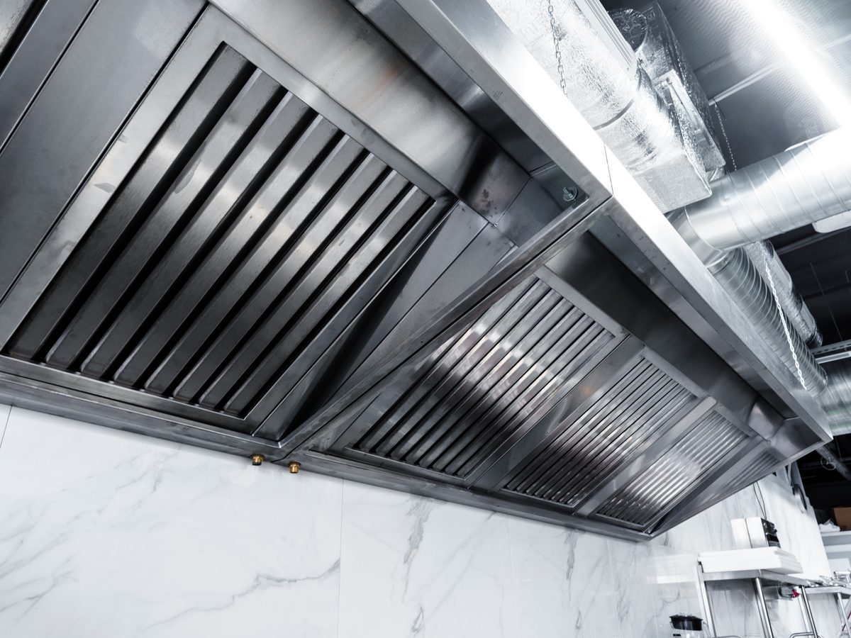 Wall-mounted stainless steel range hood with baffle filters and ductwork