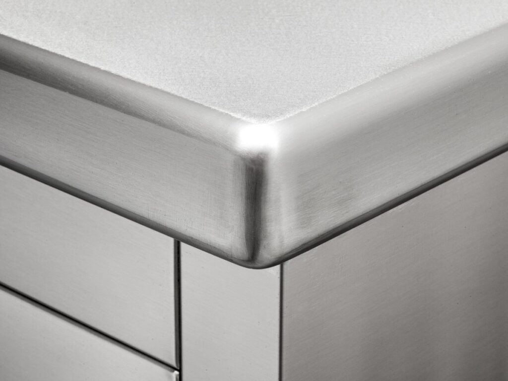 Close-up of a brushed stainless steel benchtop corner