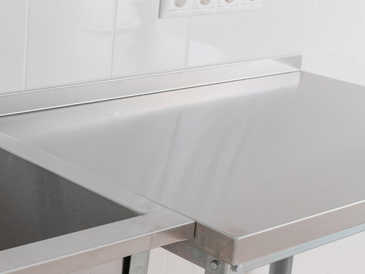 Stainless steel benchtop with a formed upstand and folded edge